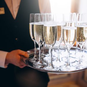 Waiter serving beverage on a tray in a restaurant